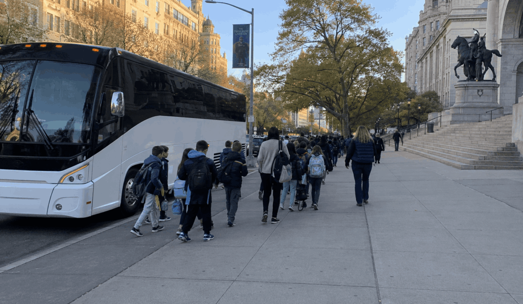 charter bus dropping off a school field trip group near the american museum of natural history in manhattan