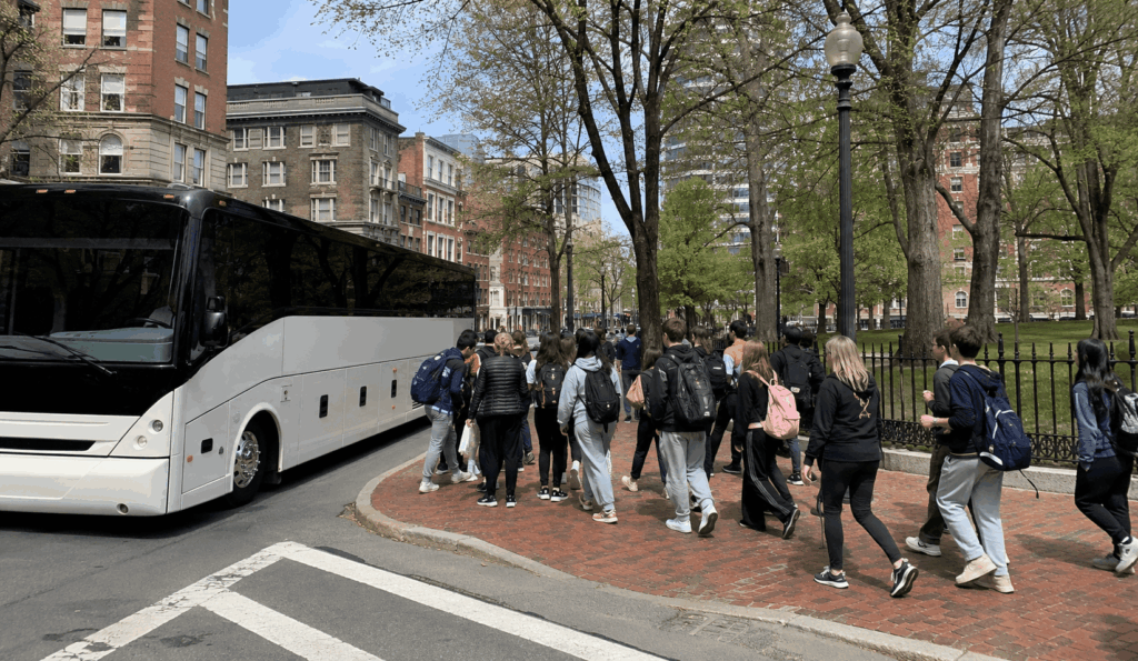 charter bus dropping off a school group near boston common for a freedom trail field trip