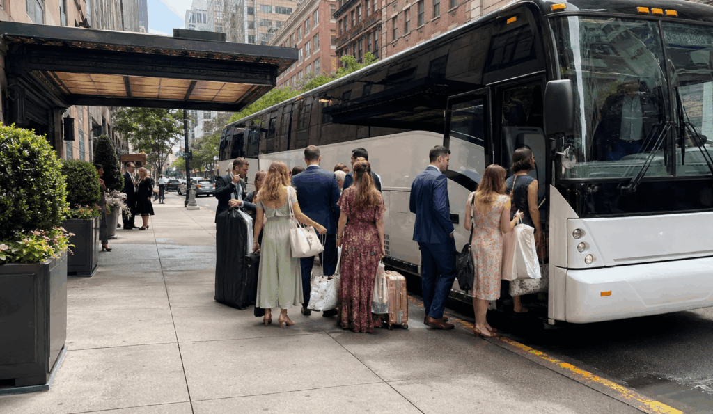 charter bus staged near a hudson valley estate wedding venue driveway during guest drop-off