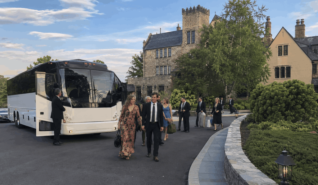 wedding shuttle bus arriving at a hudson valley estate venue with guests from new york city hotel blocks