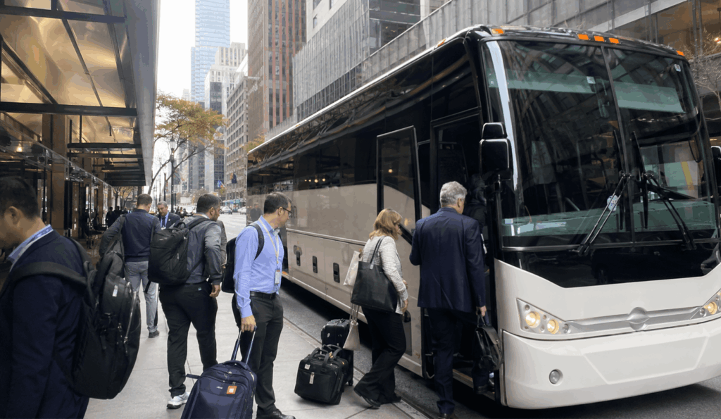wedding guests boarding a shuttle bus outside a Manhattan hotel for transportation to a ceremony venue