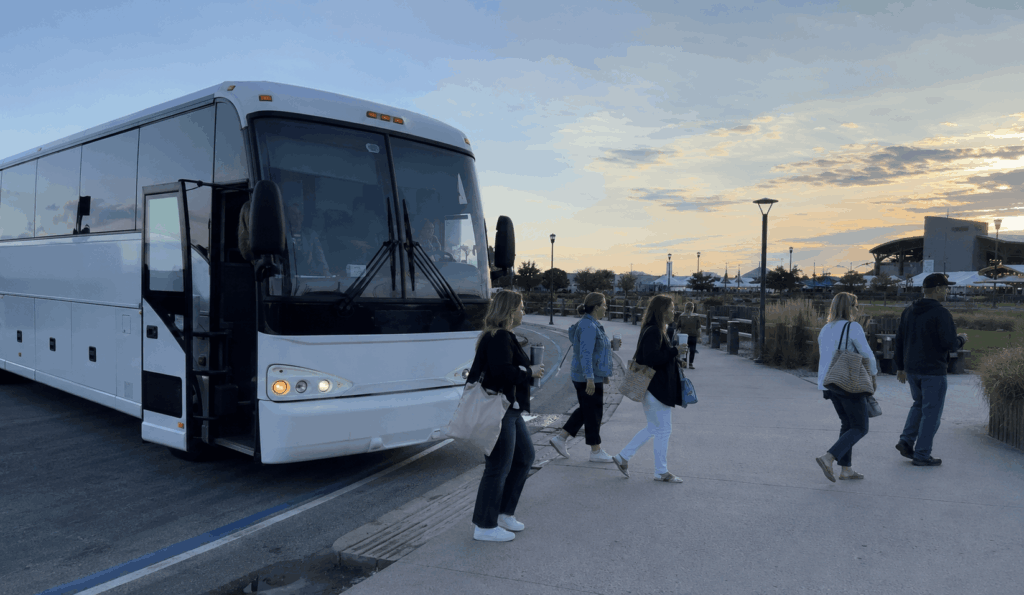 charter bus dropping off concertgoers near jones beach theater before a summer show