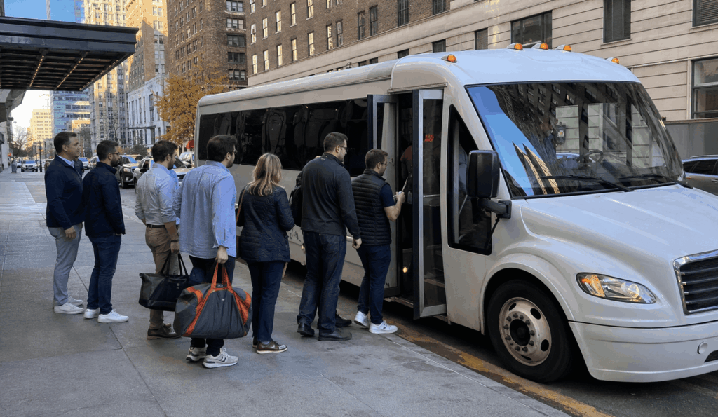 minibus picking up a small group in midtown manhattan before heading to citi field