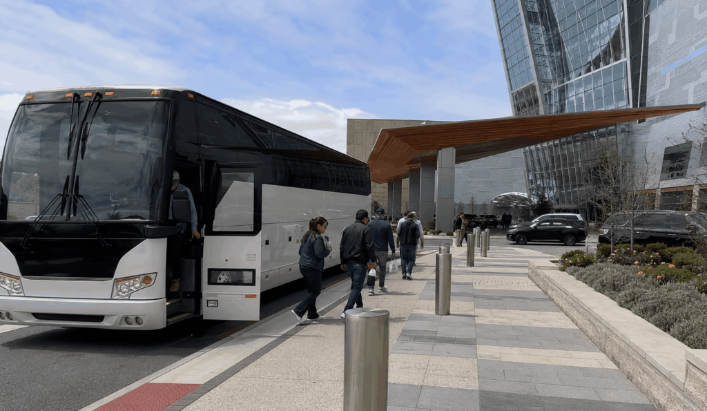 charter bus dropping off a group at the mohegan sun casino entrance in uncasville, connecticut