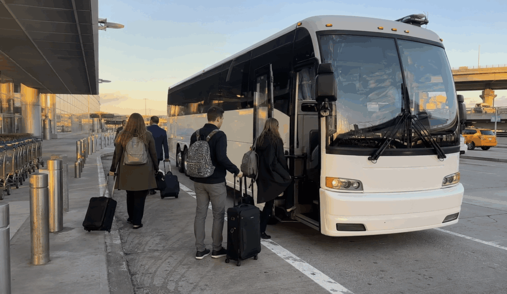 travelers boarding a charter bus outside a new york city airport terminal