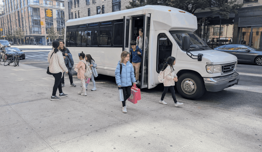 minibus dropping off families for a kids birthday party at a nyc family entertainment venue