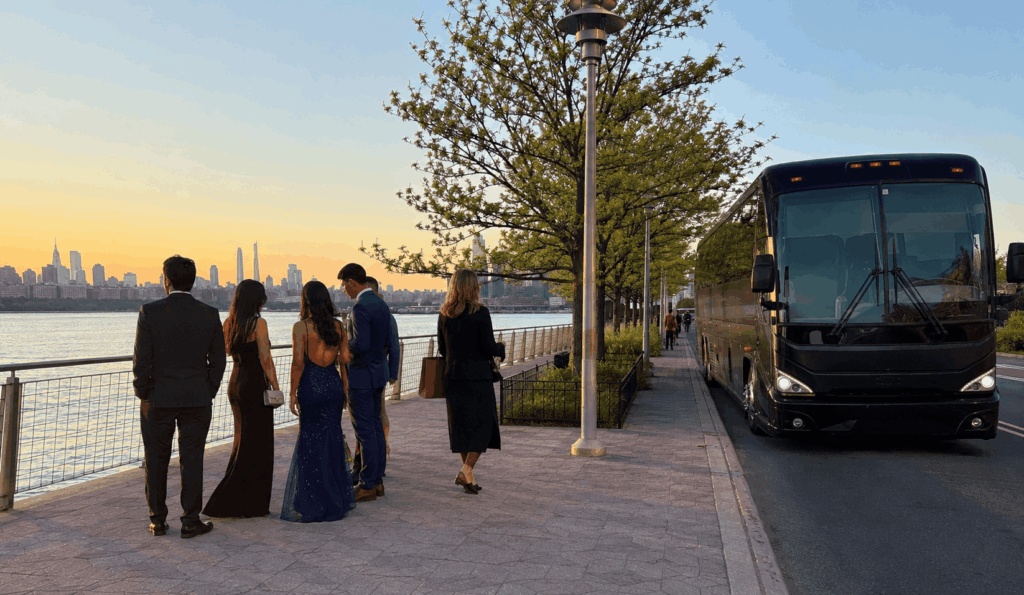 prom group stopping for photos near a new york city waterfront before riding to the venue