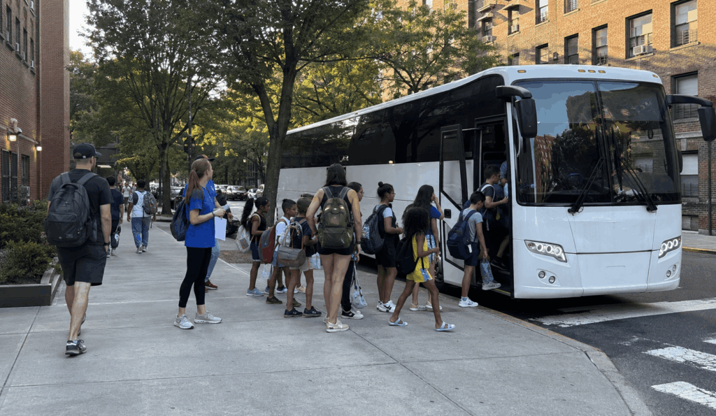 school and camp group boarding a charter bus in new york city before leaving for a six flags great adventure day trip