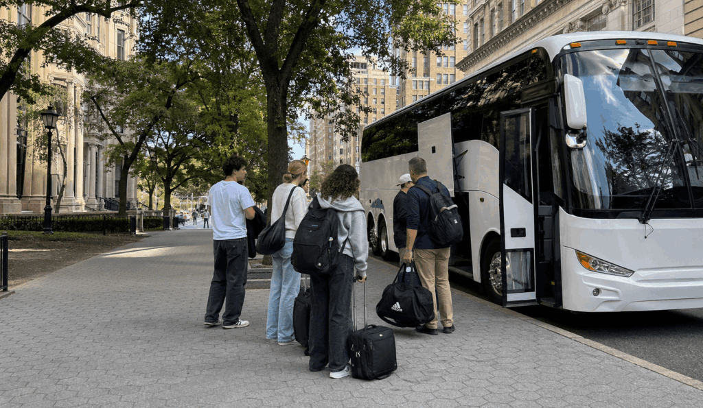 charter bus picking up a university group near a manhattan campus in new york city